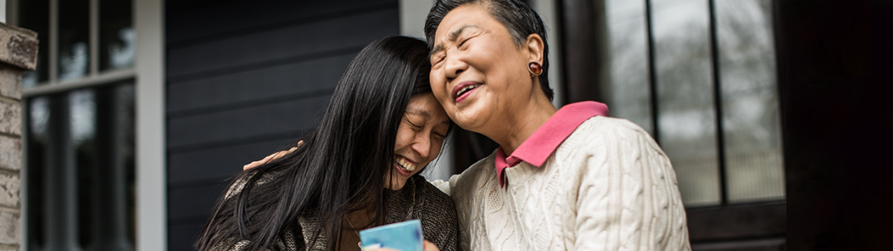 Mother and daughter share a hug and laugh together