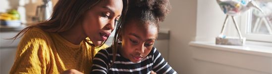 Mother doing homework with her daughter